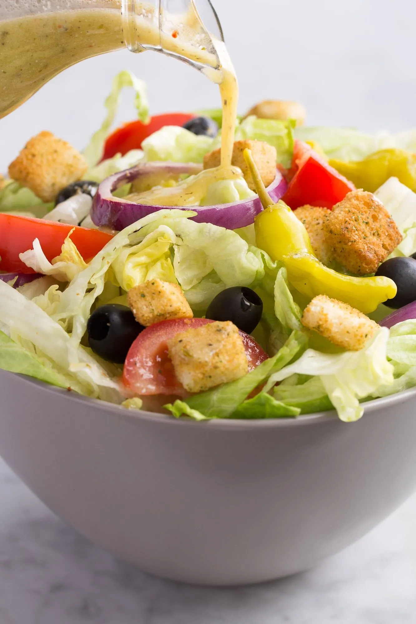 House salad with dressing poured over the top